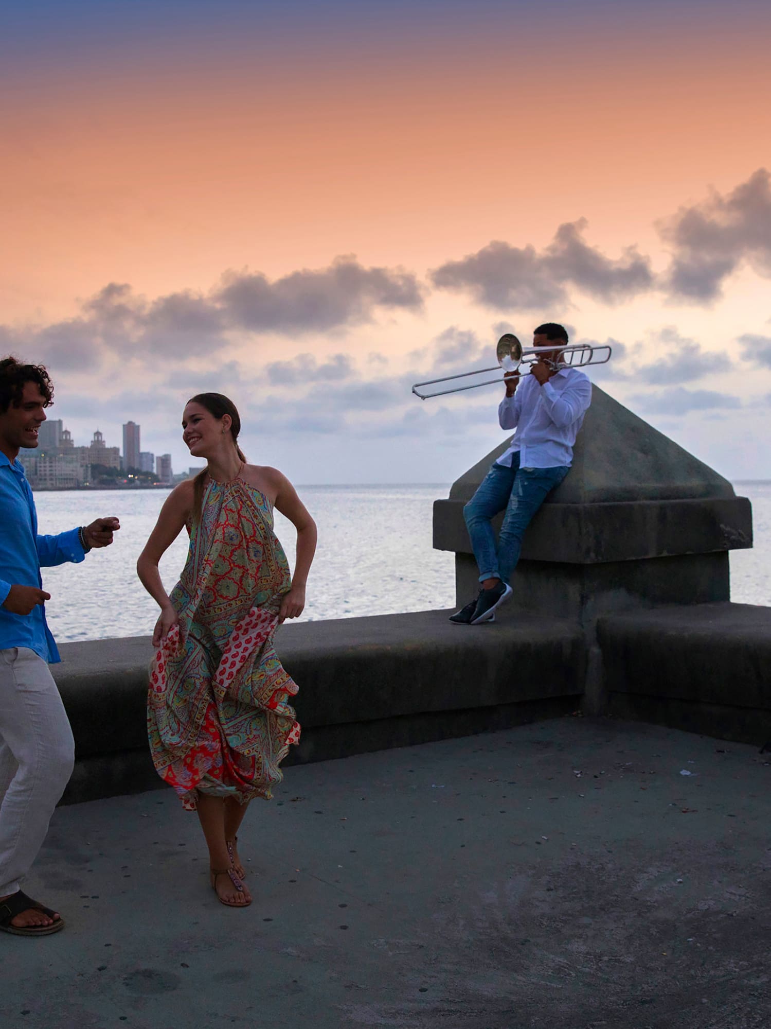 a group of people playing instruments on a concrete wall