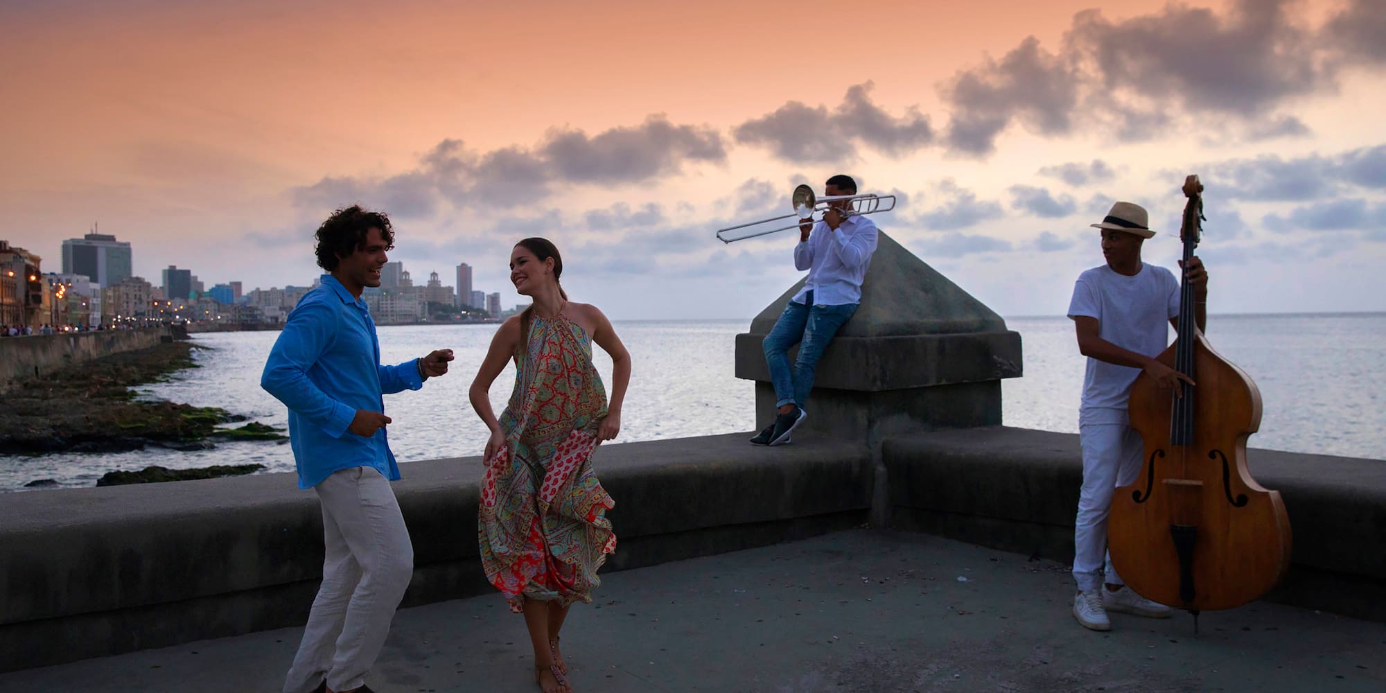a group of people playing instruments on a concrete wall