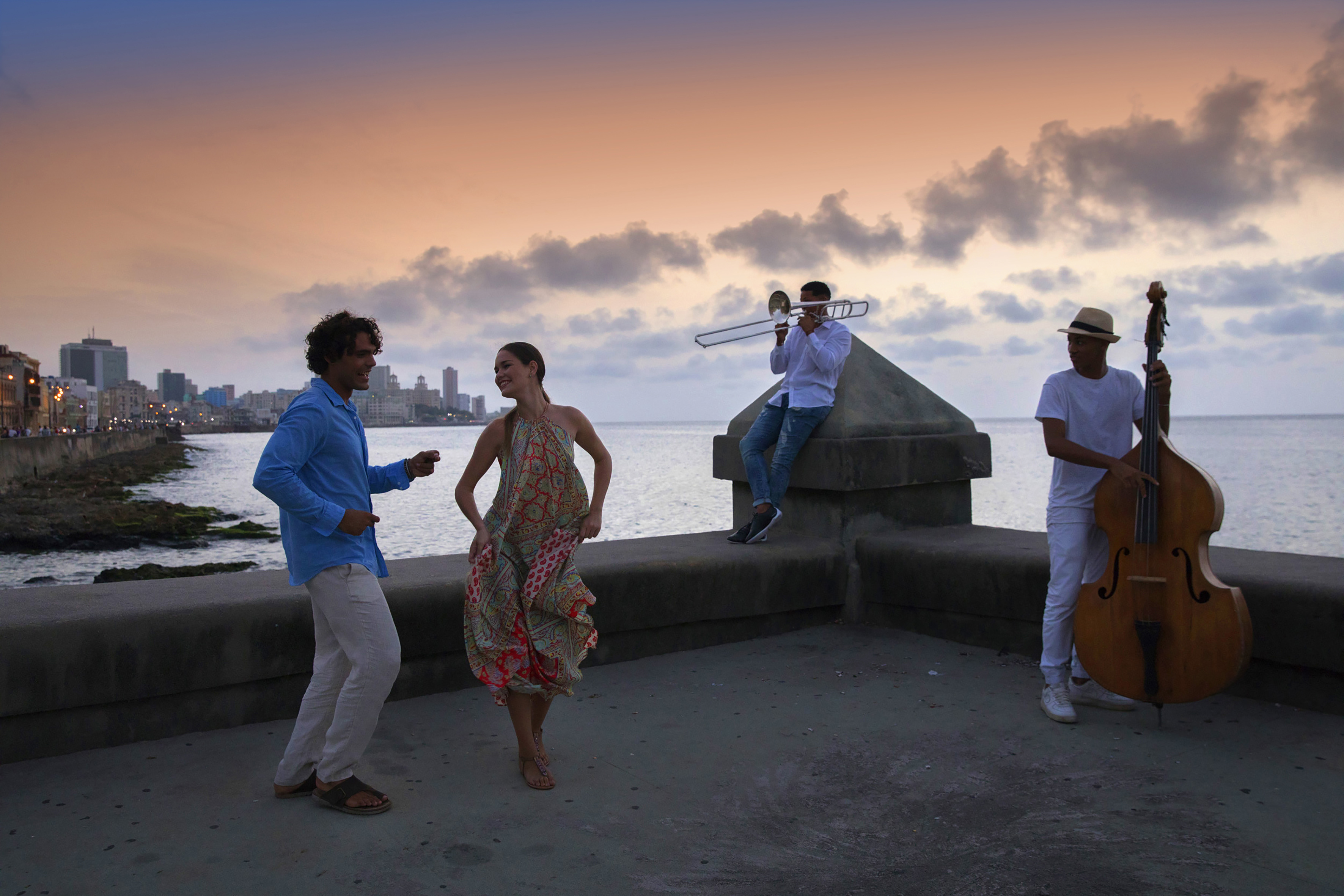 a group of people playing instruments on a concrete wall