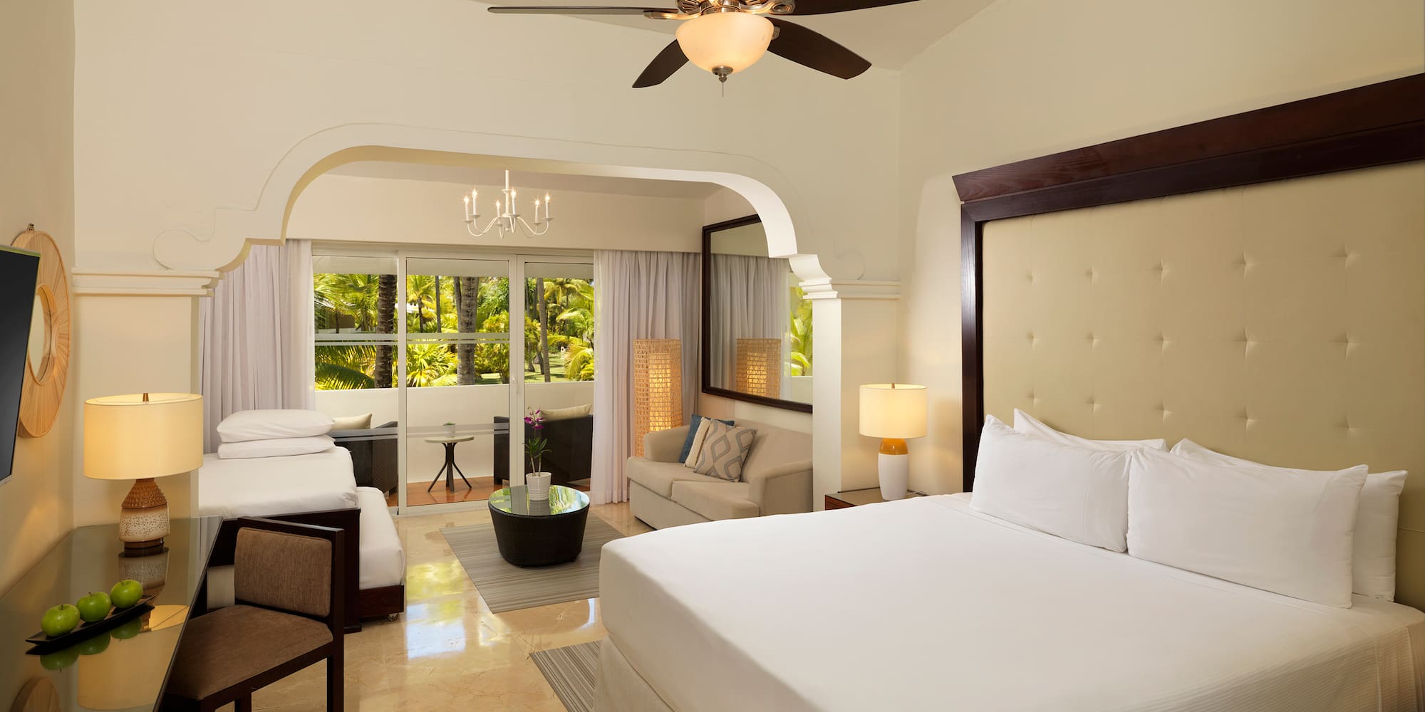 a room with a bed and a ceiling fan