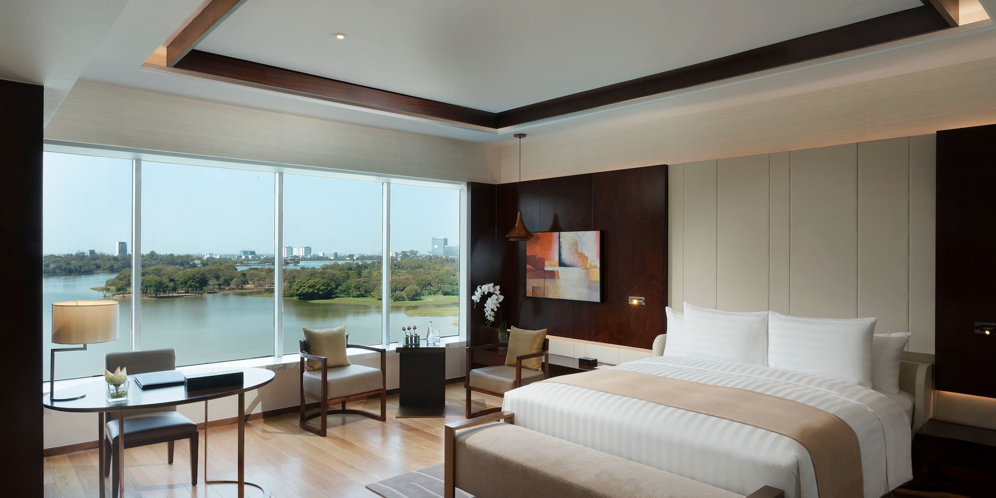 a room with a bed and a table and chairs