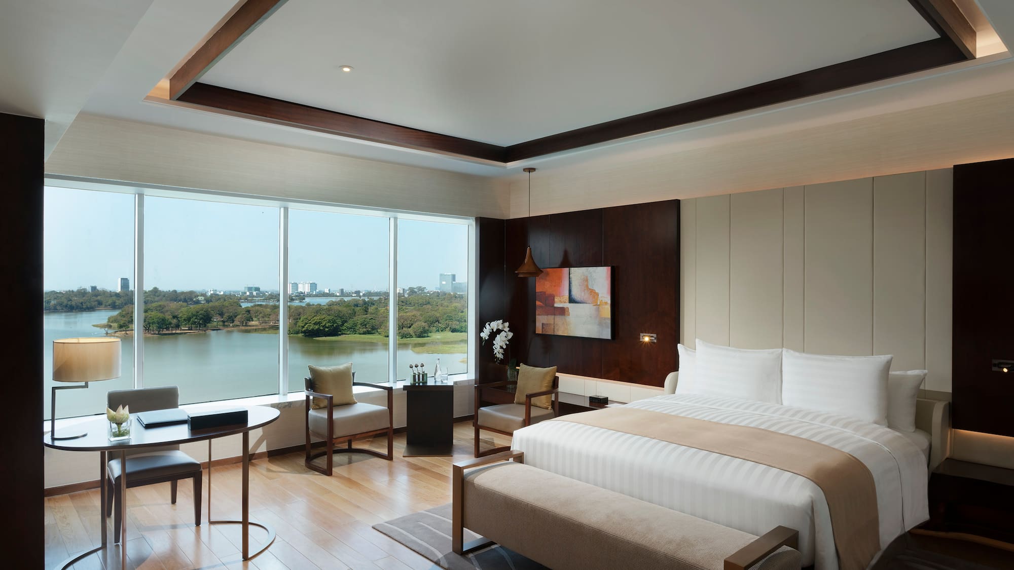 a room with a bed and a table and chairs