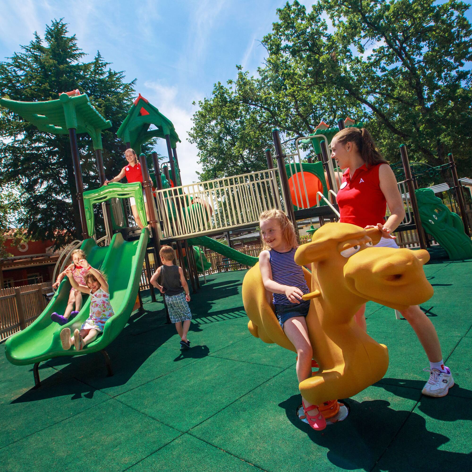 a woman and kids at a playground