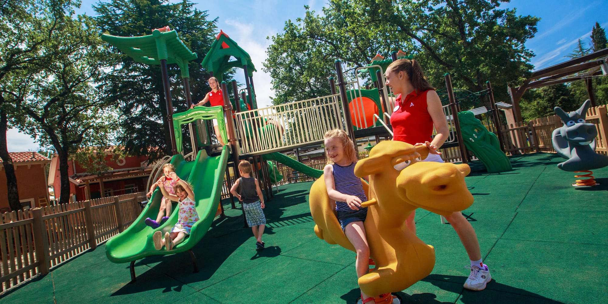 a woman and kids at a playground
