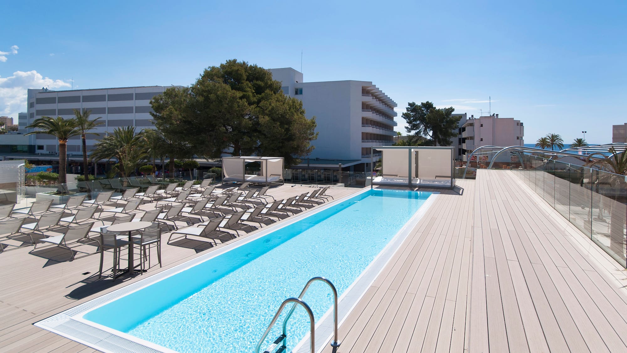 a pool with chairs and a deck