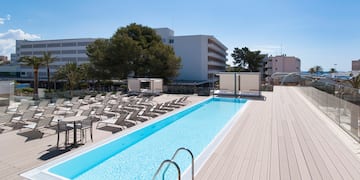 a pool with chairs and a deck