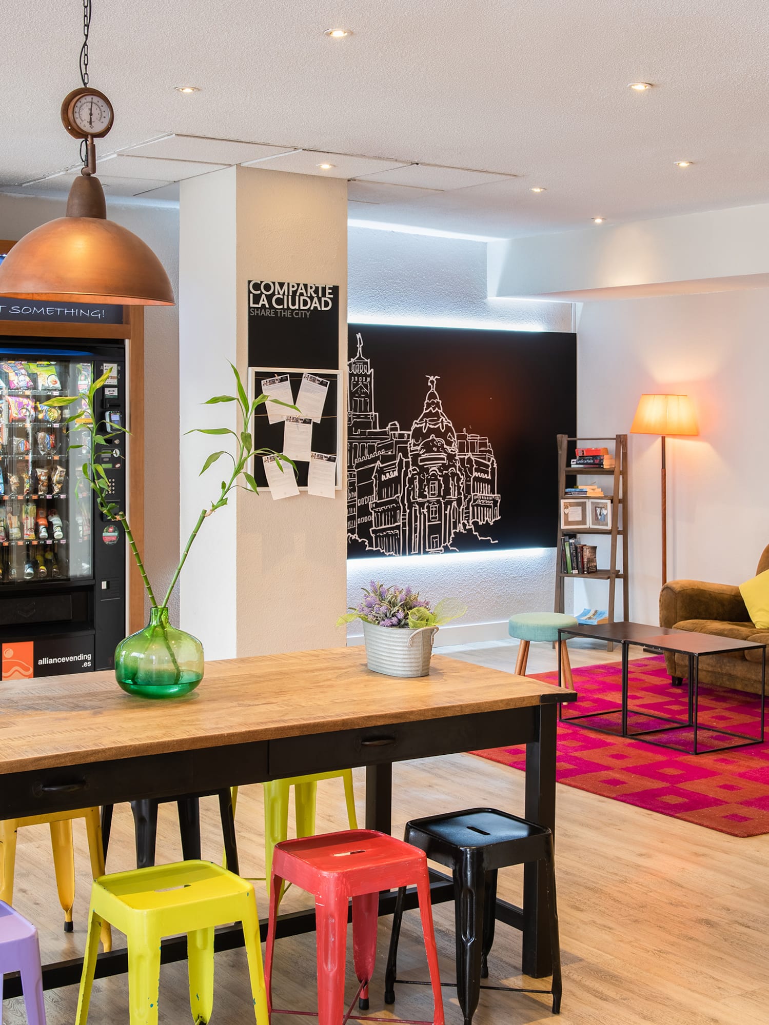 a room with a couch and a table with colorful stools