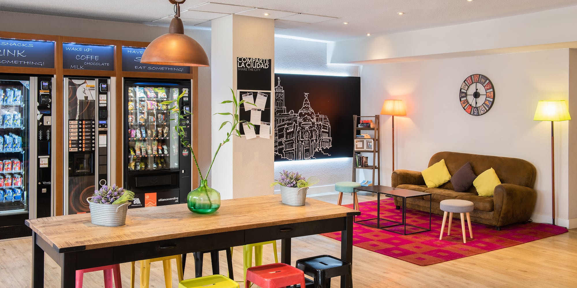 a room with a couch and a table with colorful stools