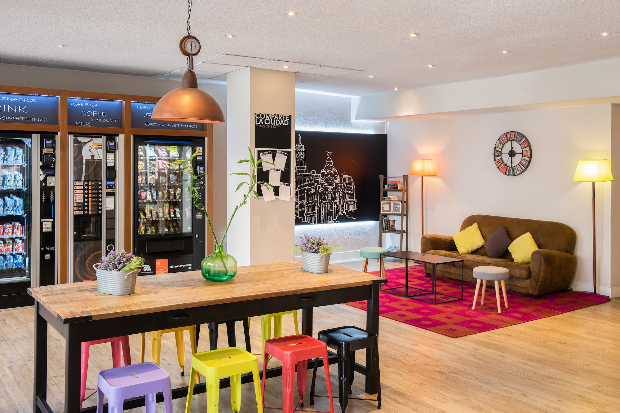 a room with a couch and a table with colorful stools