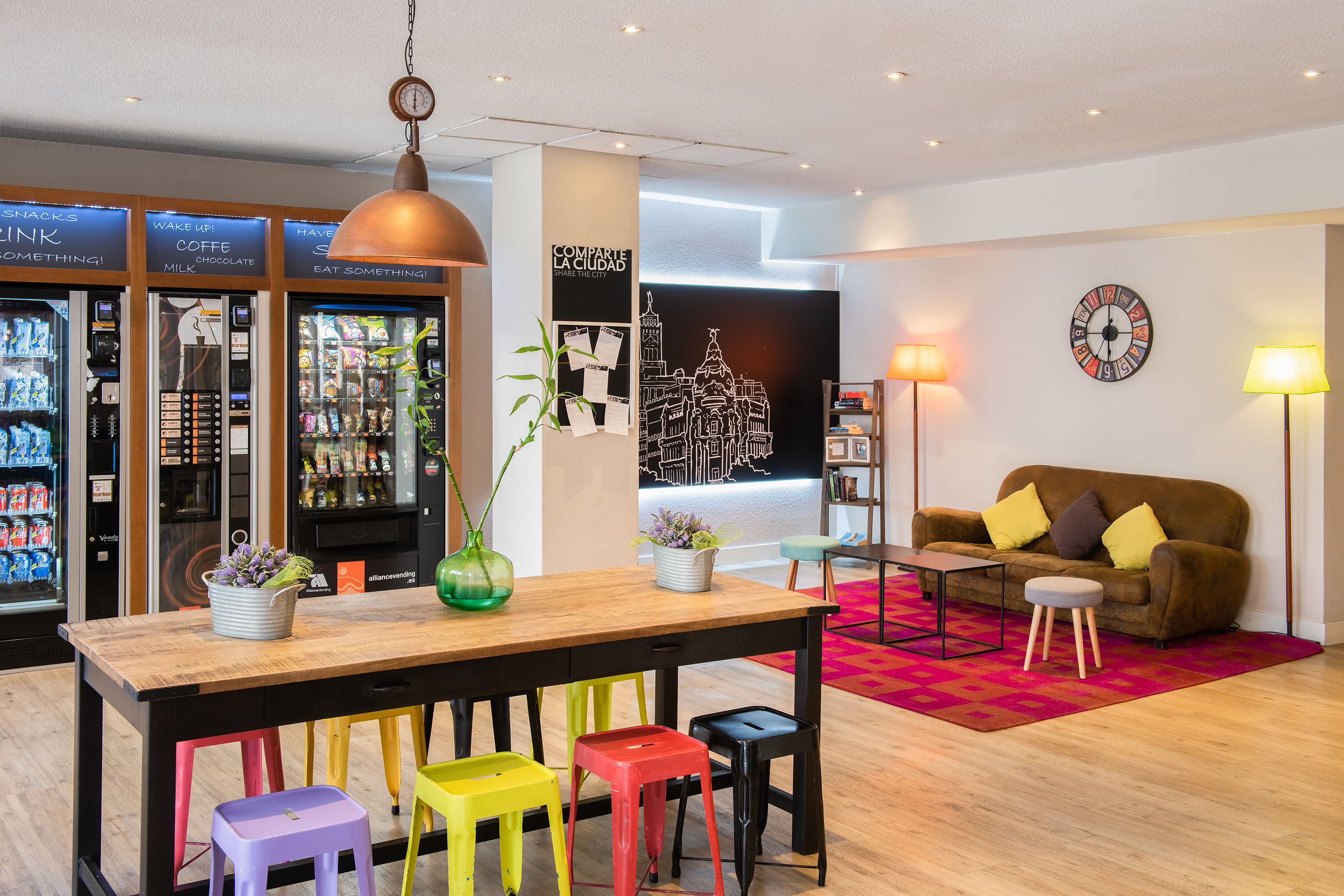 a room with a couch and a table with colorful stools