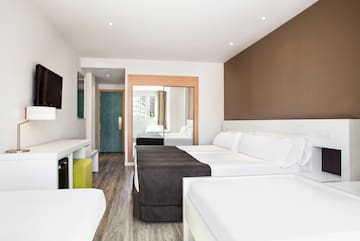 a room with two beds and a mirror