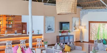 a room with white furniture and a large ceiling