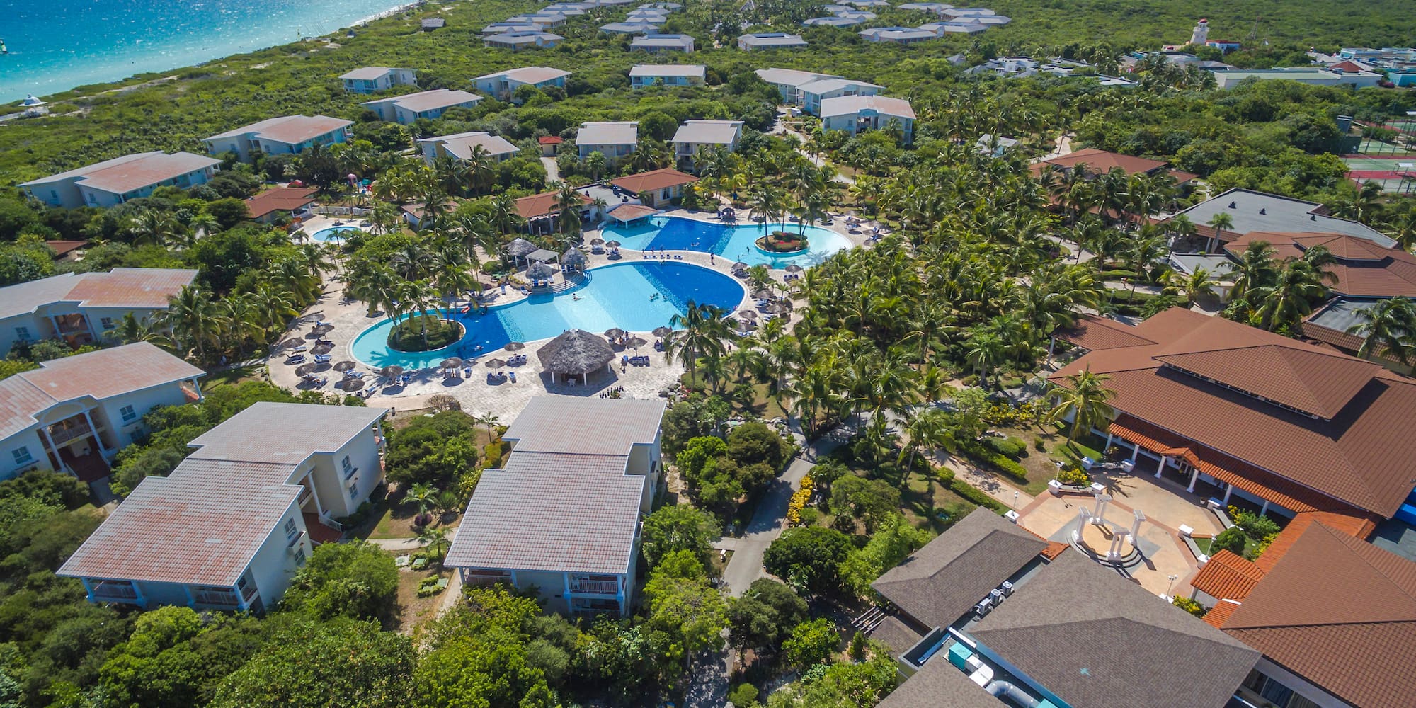 a swimming pool surrounded by trees and buildings