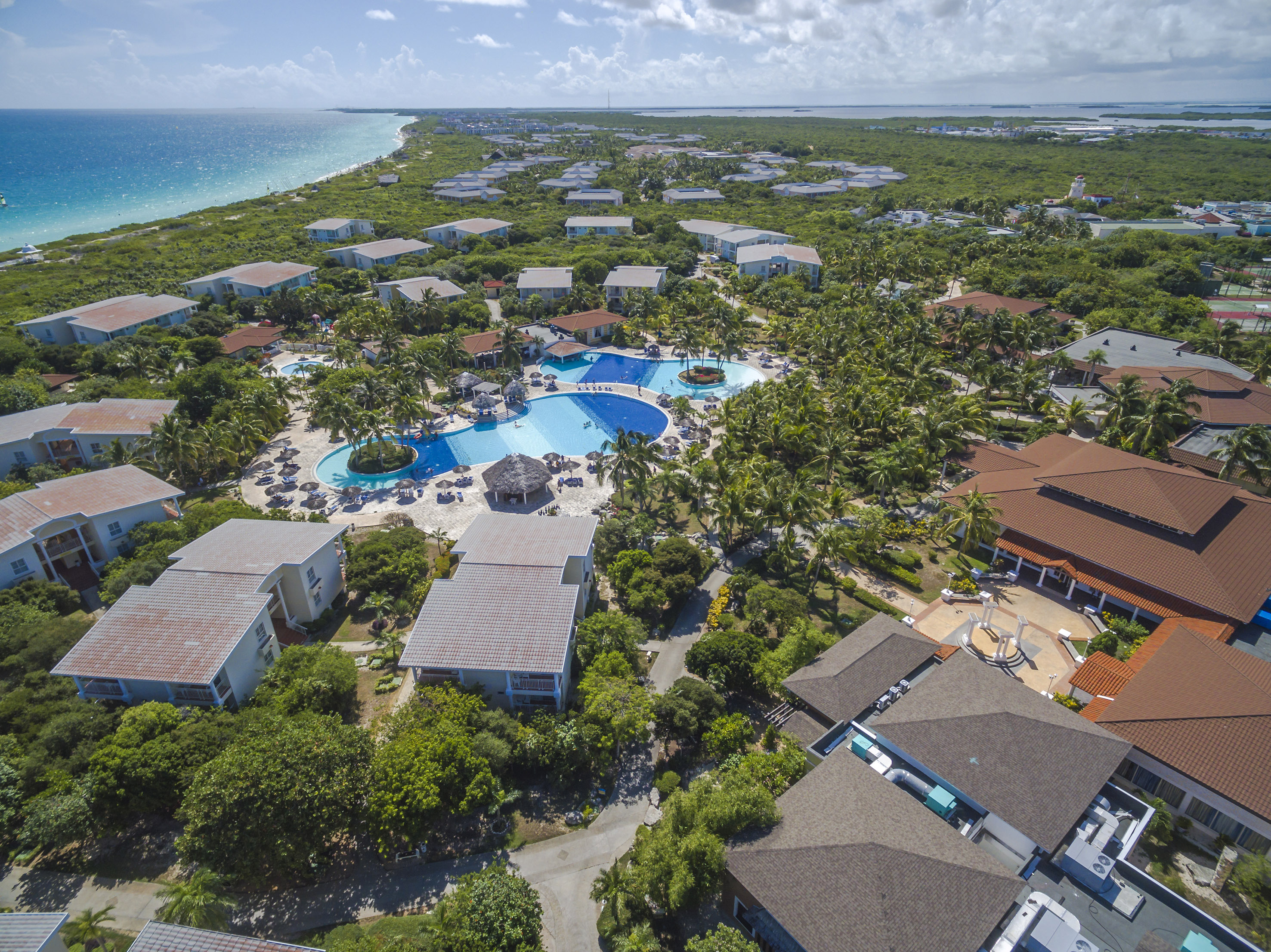 a swimming pool surrounded by trees and buildings