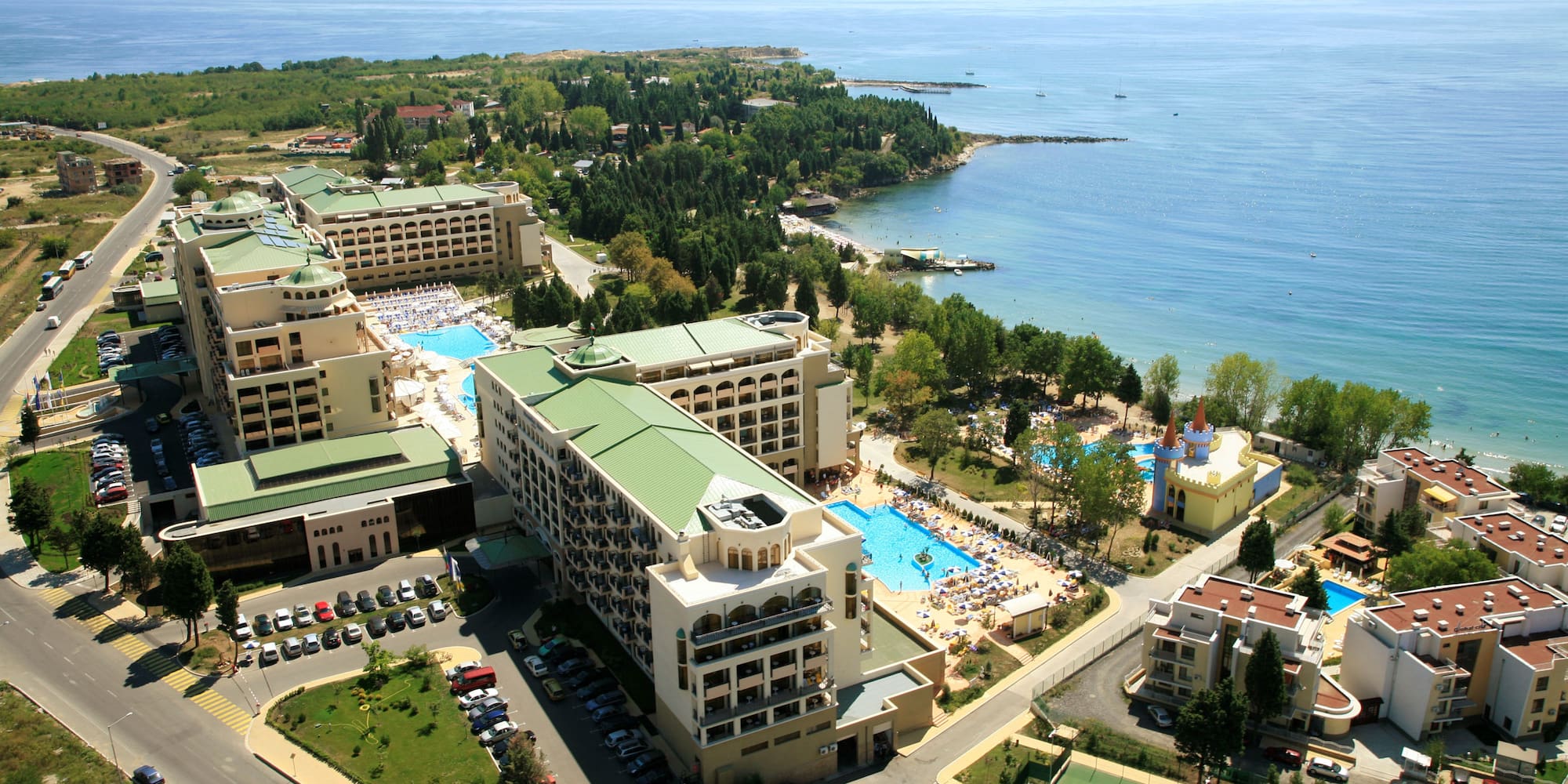 a aerial view of a resort with a swimming pool and a beach