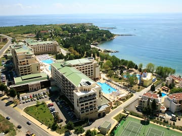 a aerial view of a resort with a swimming pool and a beach