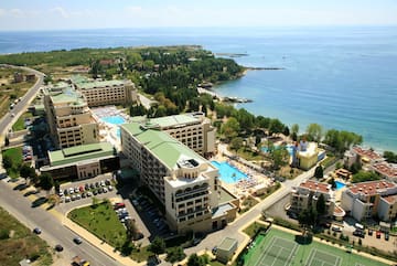 a aerial view of a resort with a swimming pool and a beach