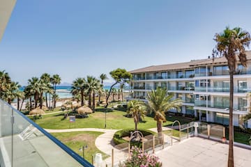 a building with palm trees and a lawn