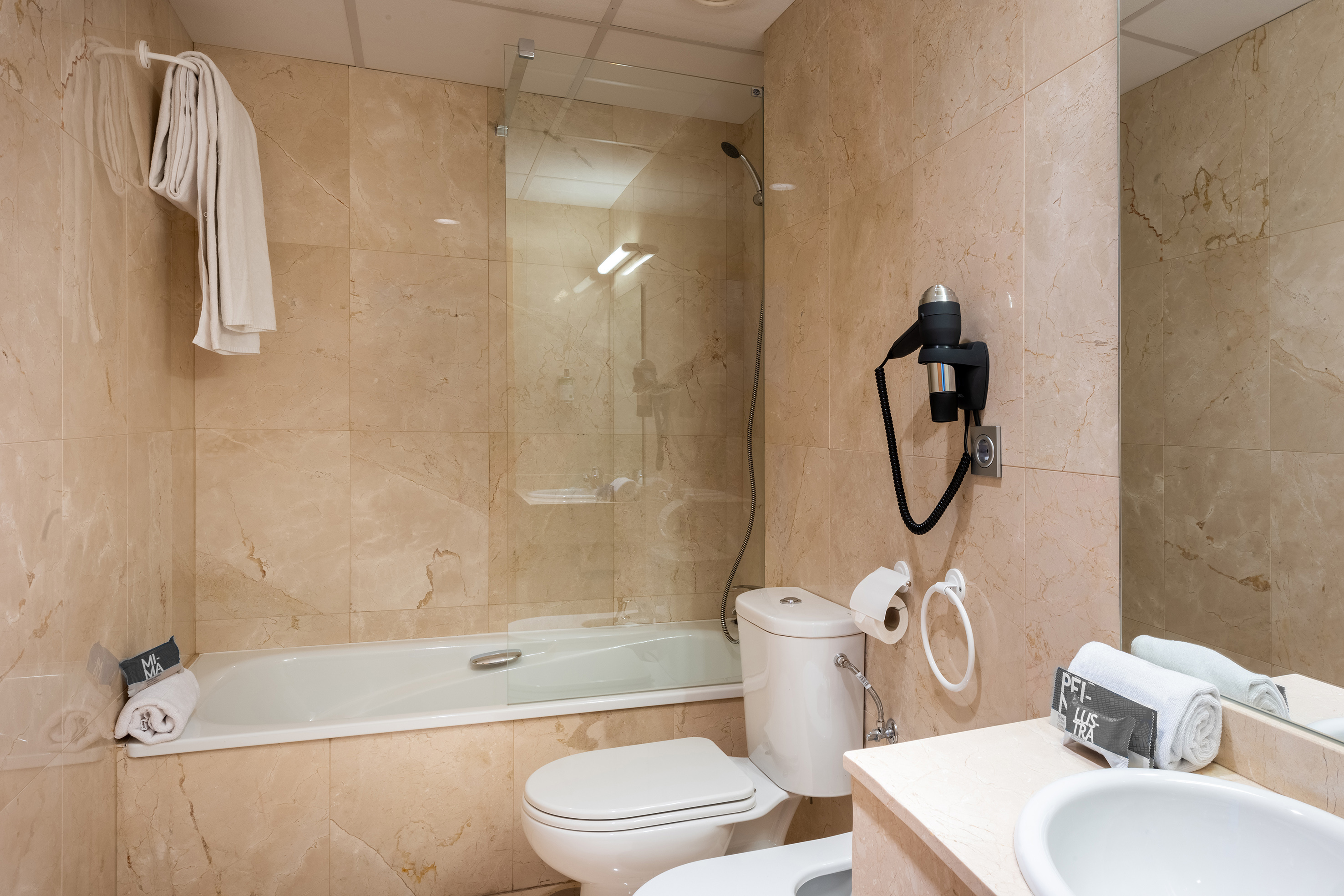 a bathroom with a glass shower door
