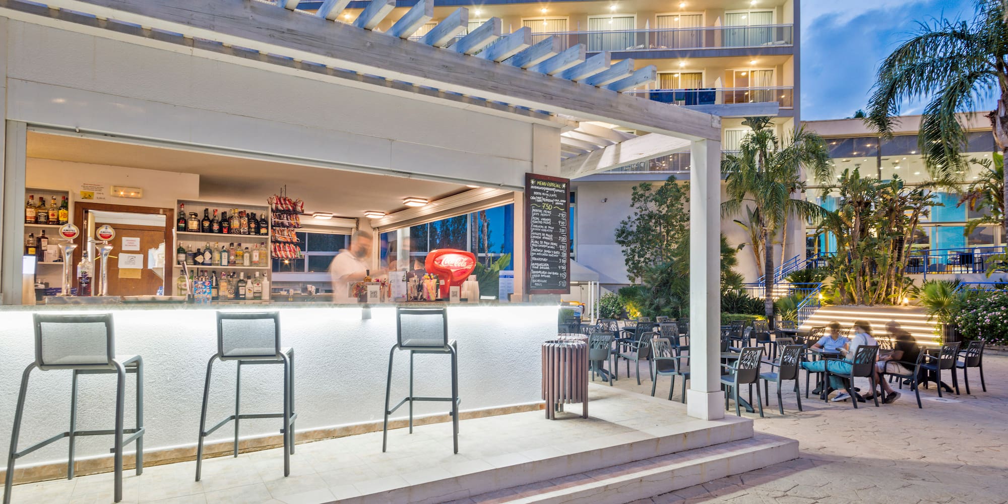 a bar with chairs outside of a building