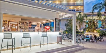 a bar with chairs outside of a building