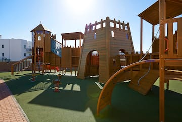 a playground with a structure and a slide