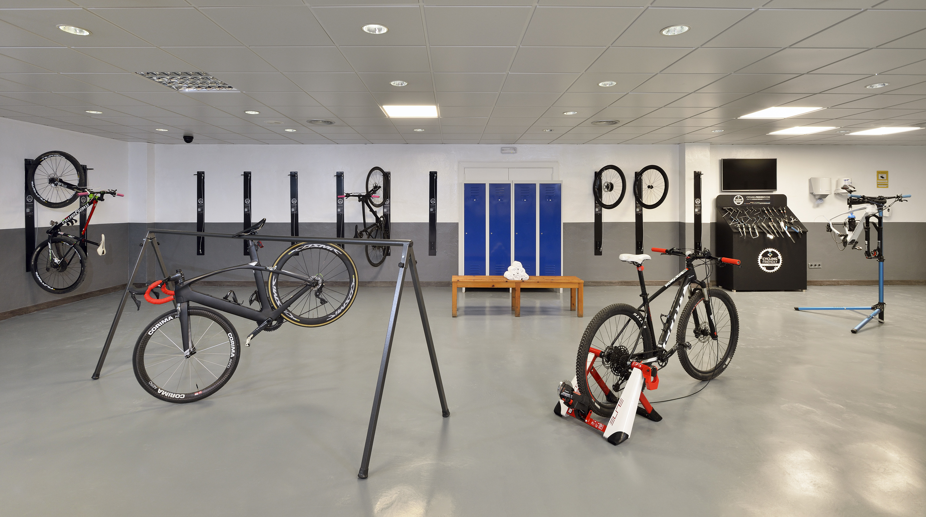 Cycling friendly bike station: storage, repair tools, indoor trainer, lockers.