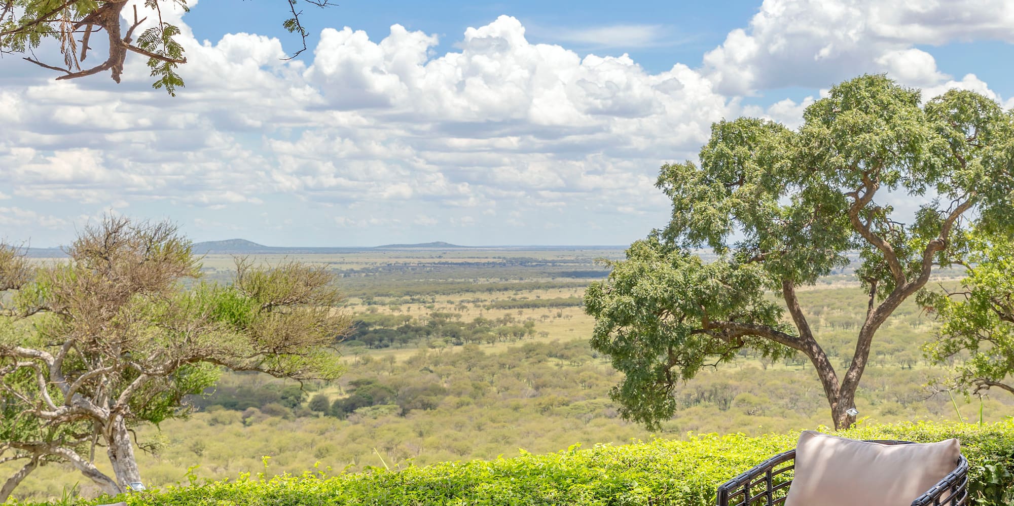 a patio with chairs and a table