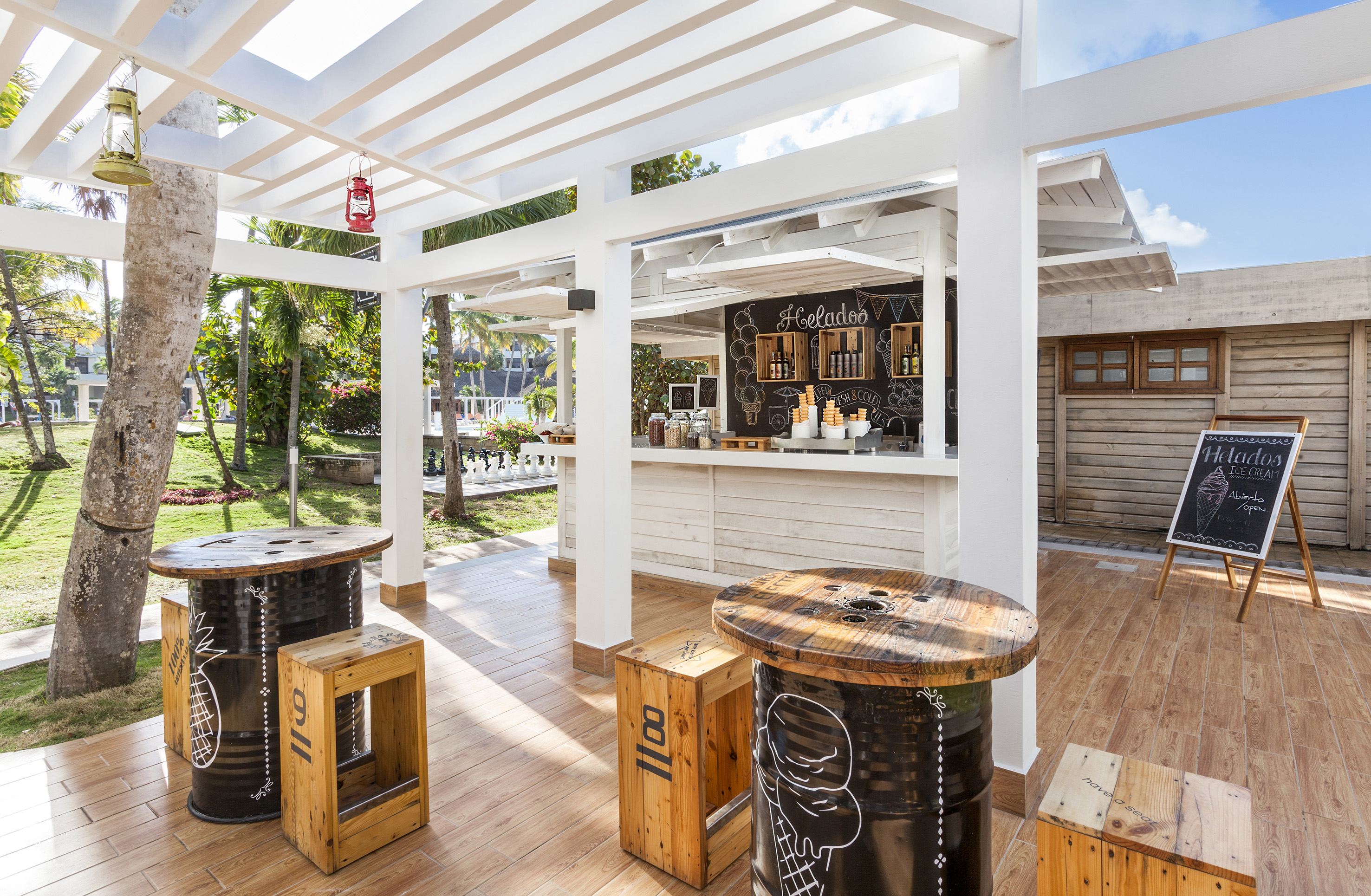 a patio with tables and chairs