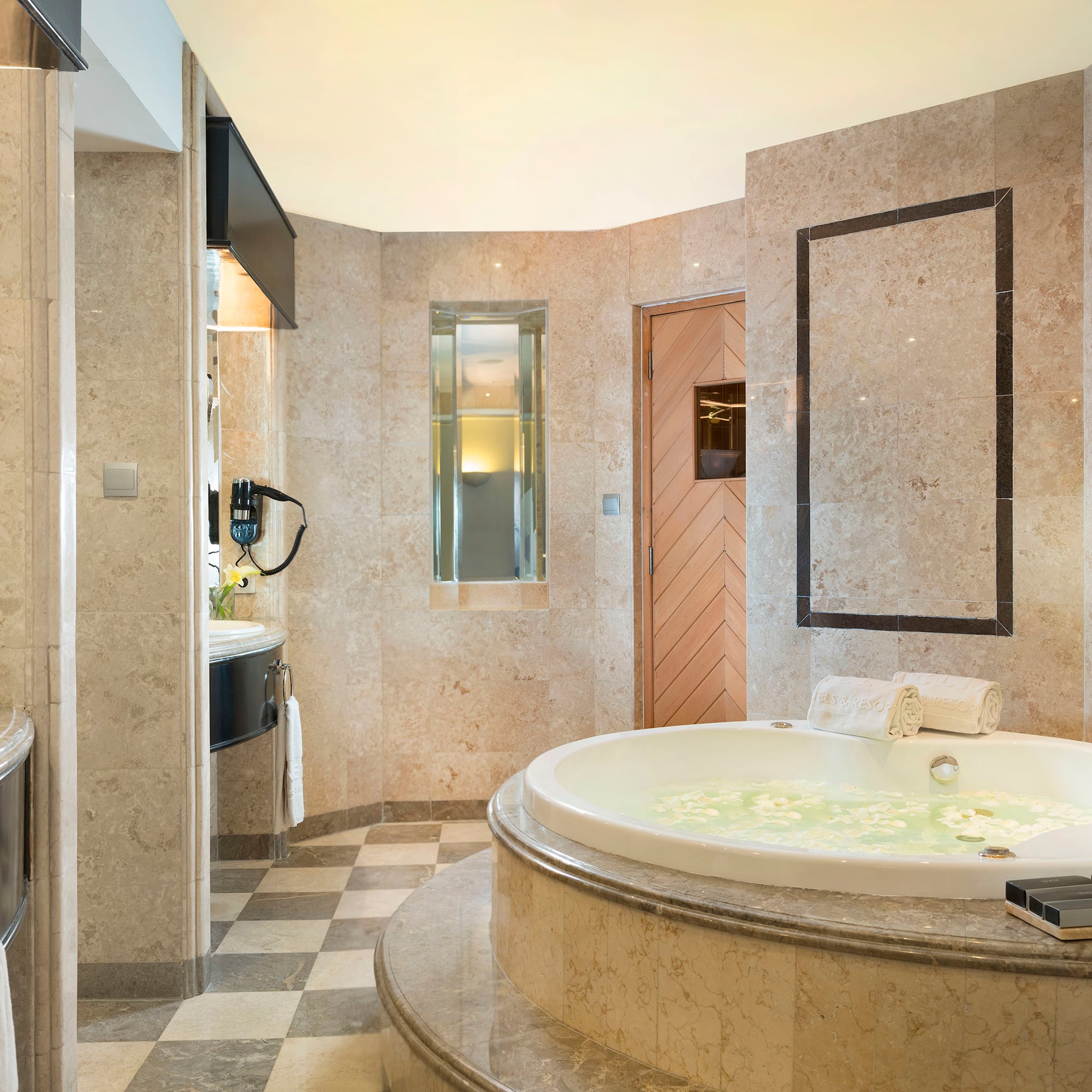 a bathroom with a large tub and a sink