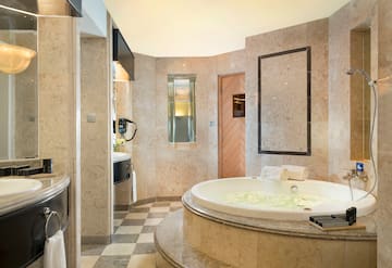 a bathroom with a large tub and a sink