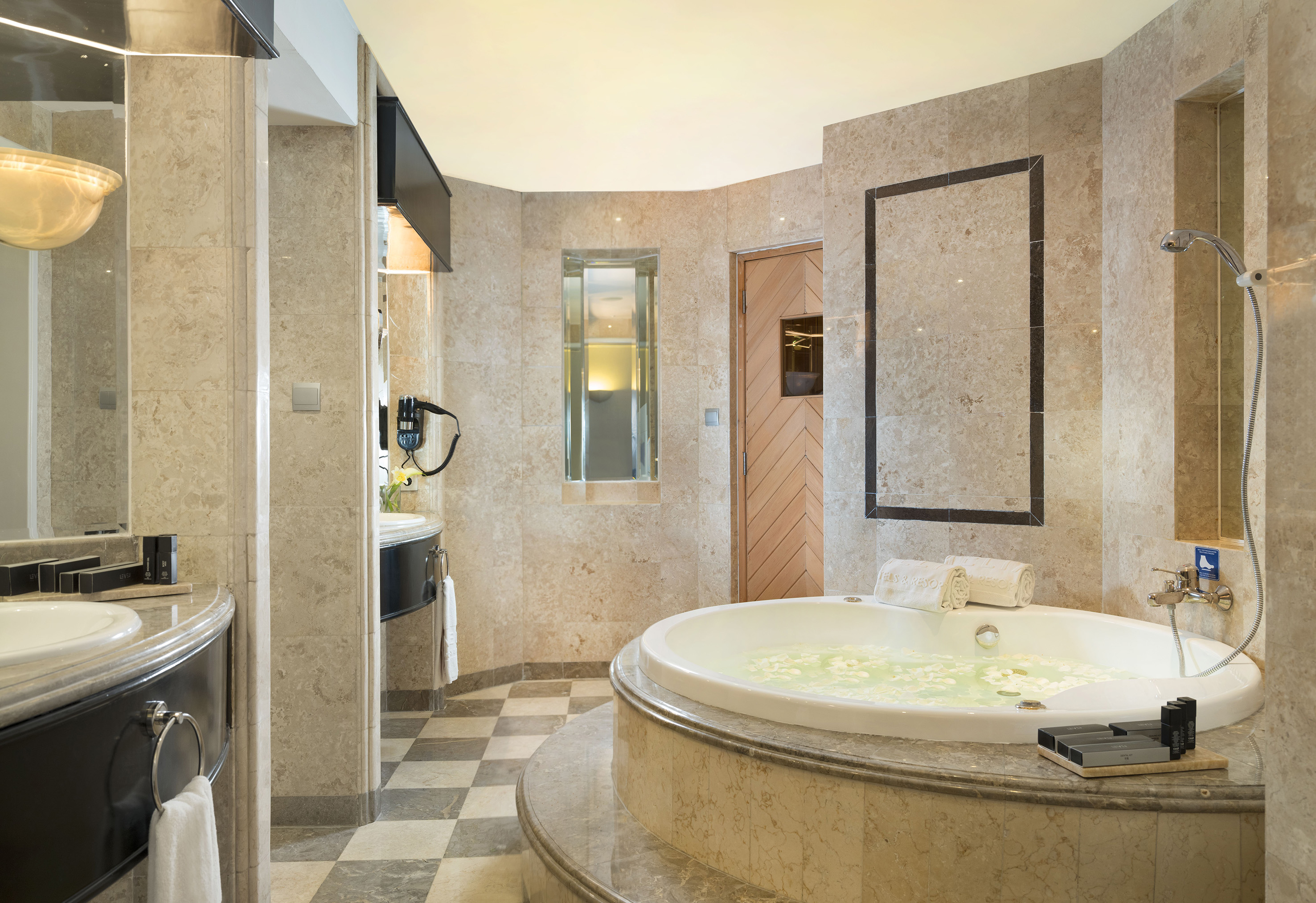 a bathroom with a large tub and a sink