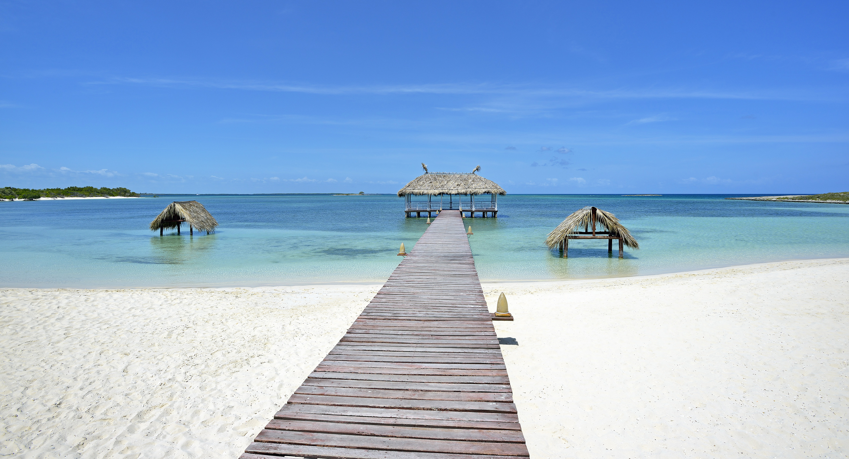 a dock leading to a beach