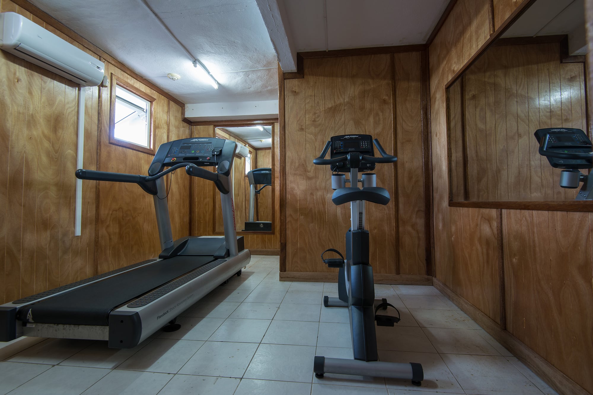a room with treadmills and exercise bikes