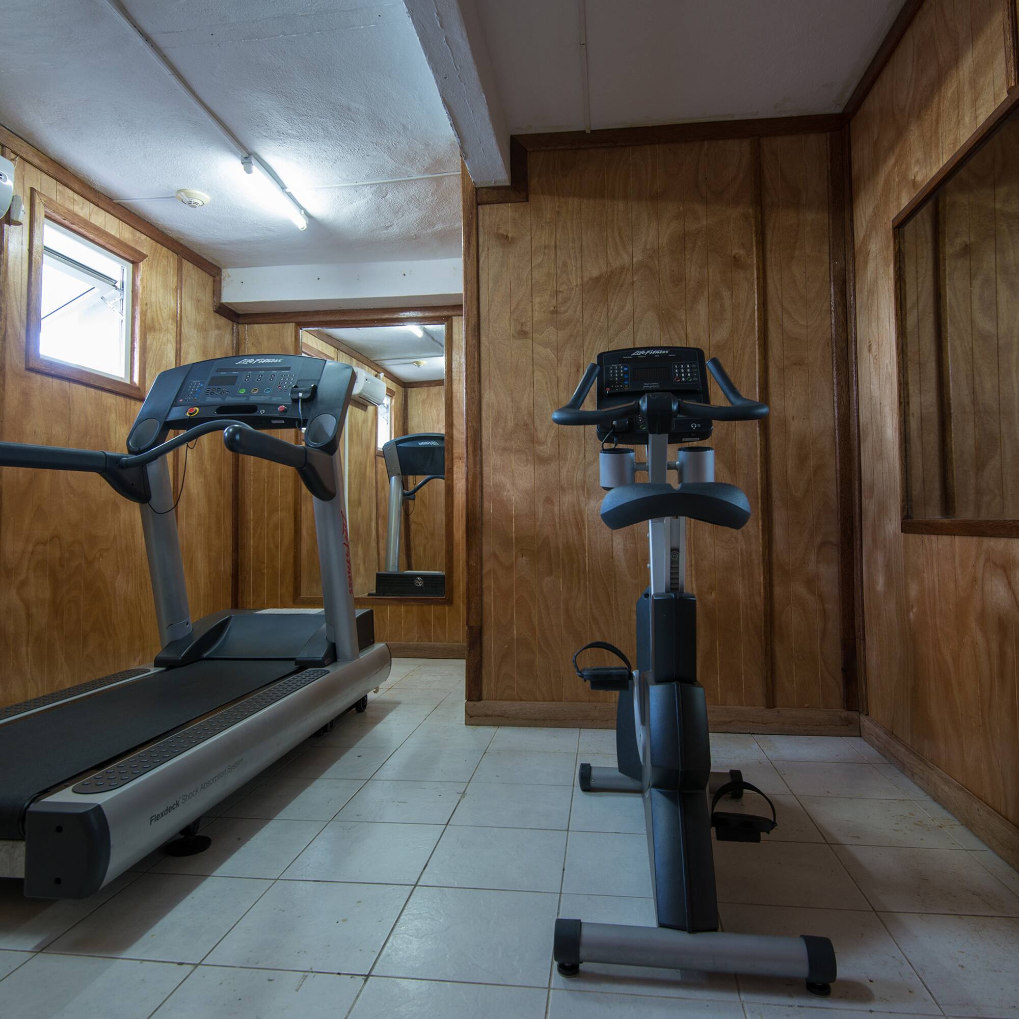 a room with treadmills and exercise bikes