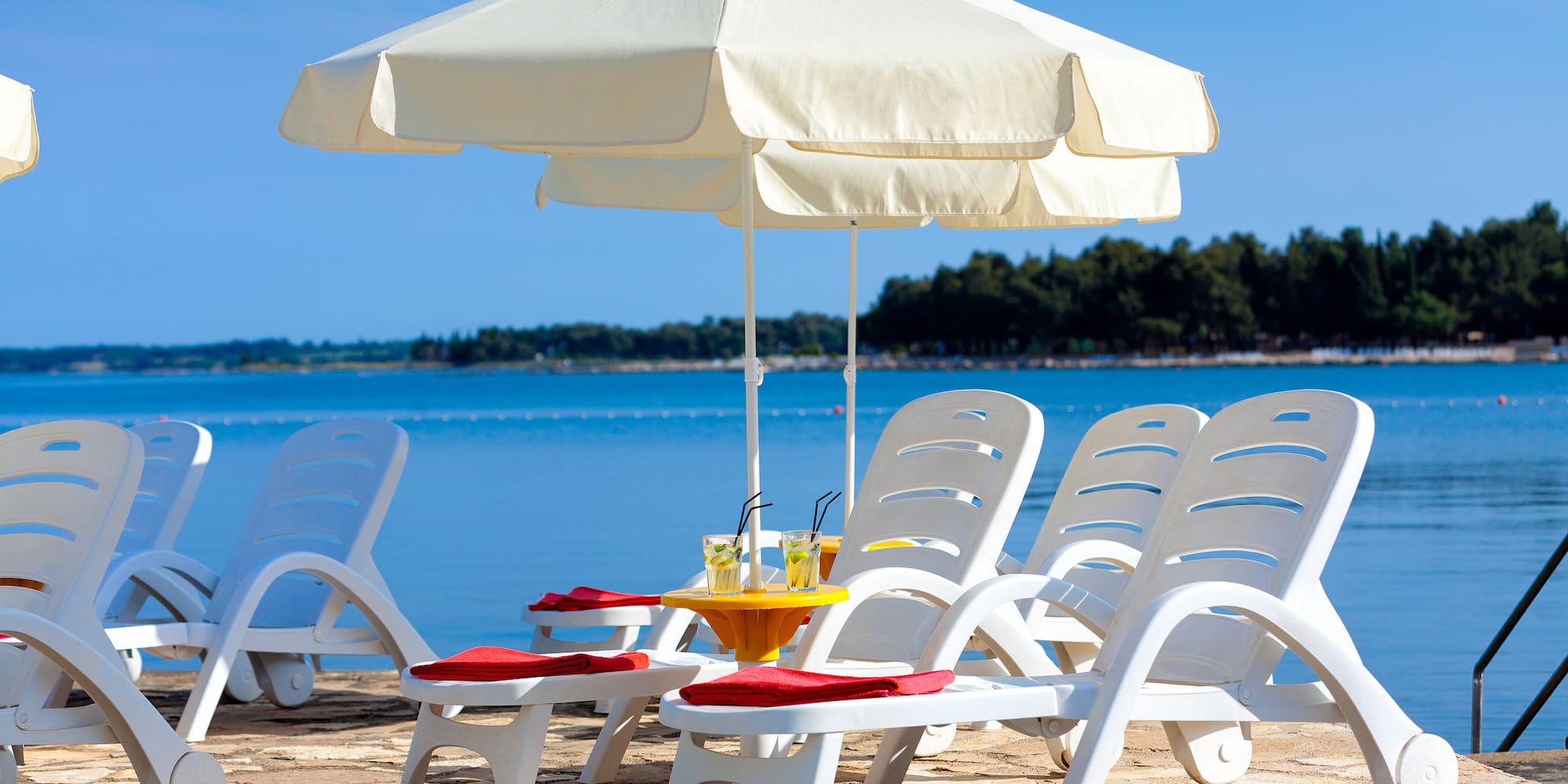 a beach chair and umbrella on a beach