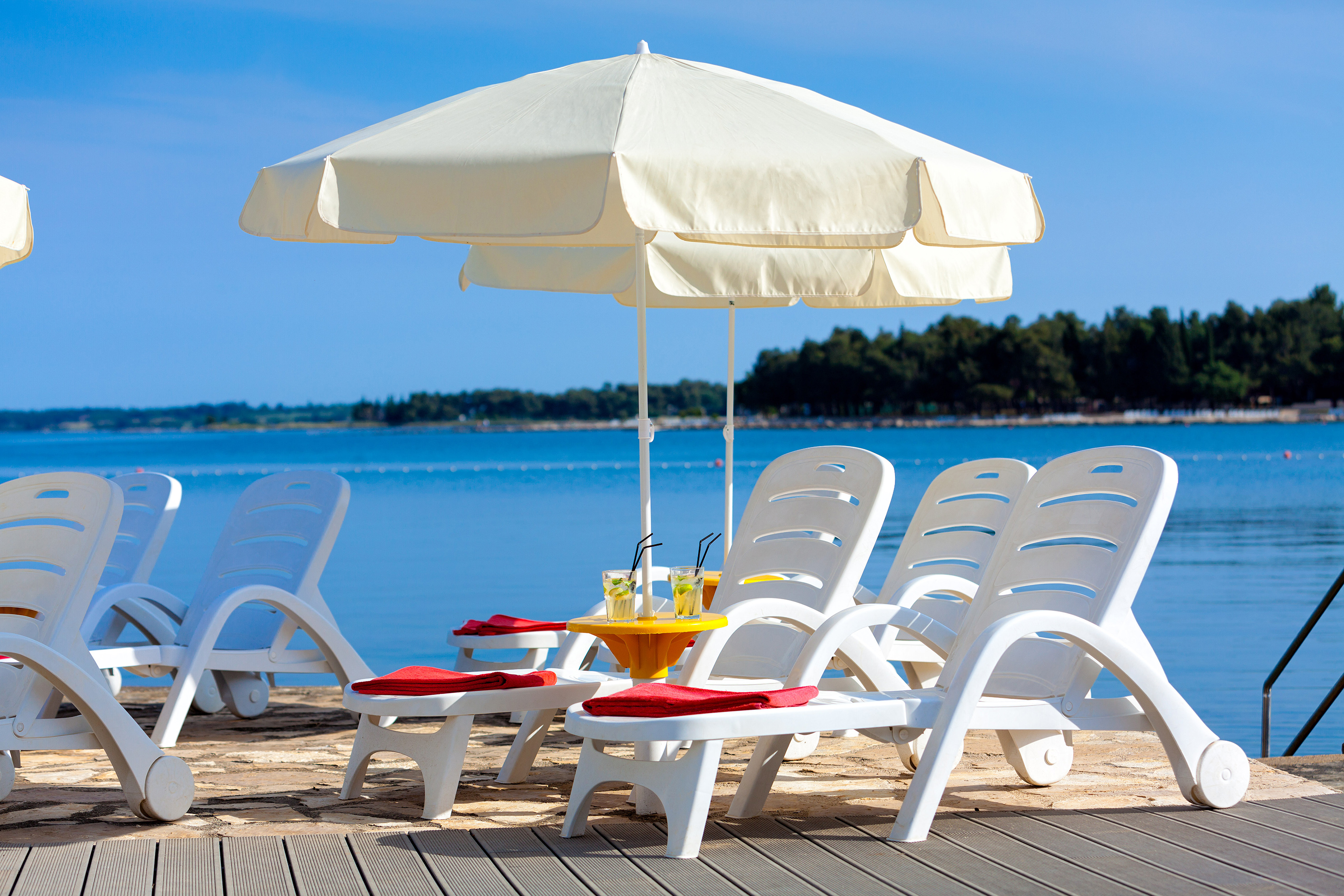 a beach chair and umbrella on a beach