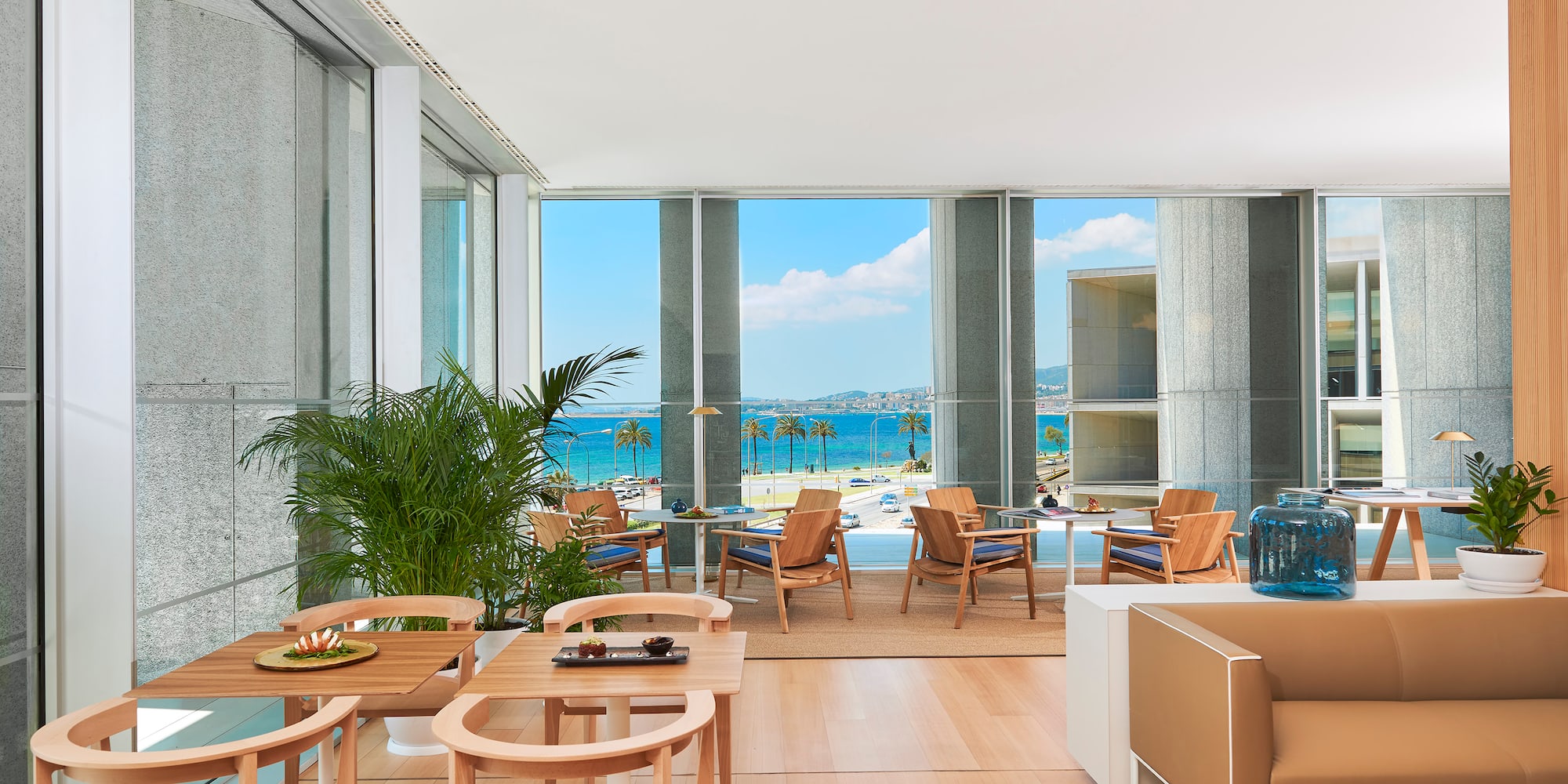 a room with a view of the ocean and a beach