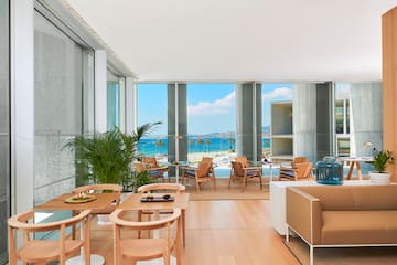 a room with a view of the ocean and a beach