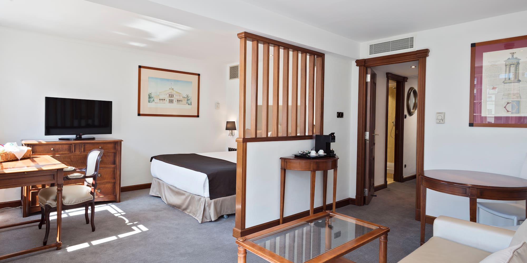 a room with a bed and a television