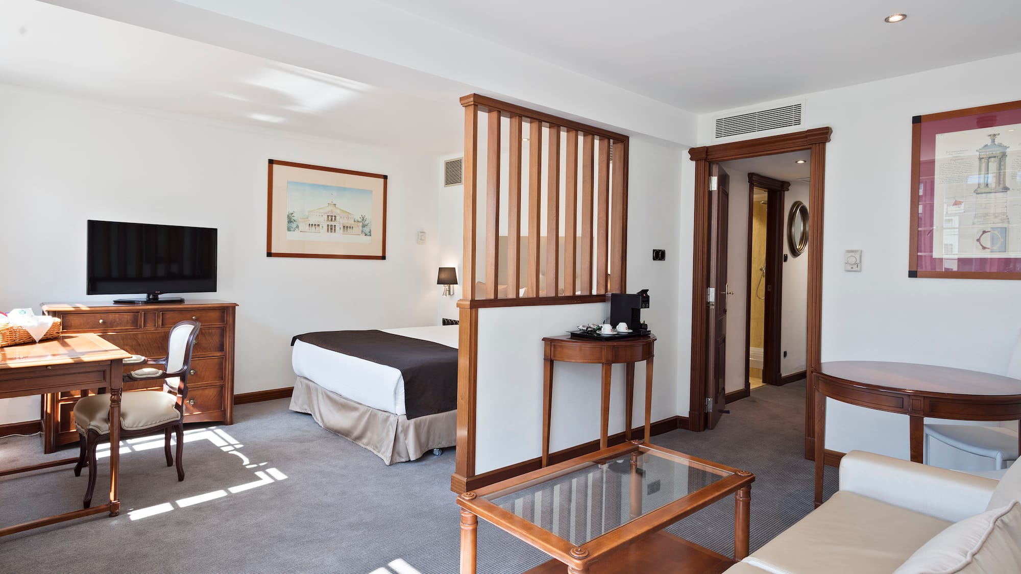 a room with a bed and a television