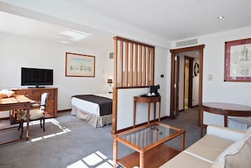 a room with a bed and a television