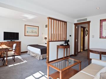 a room with a bed and a television