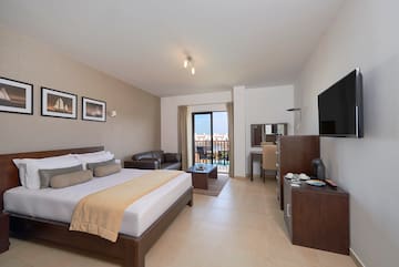 a bedroom with a television and a bed