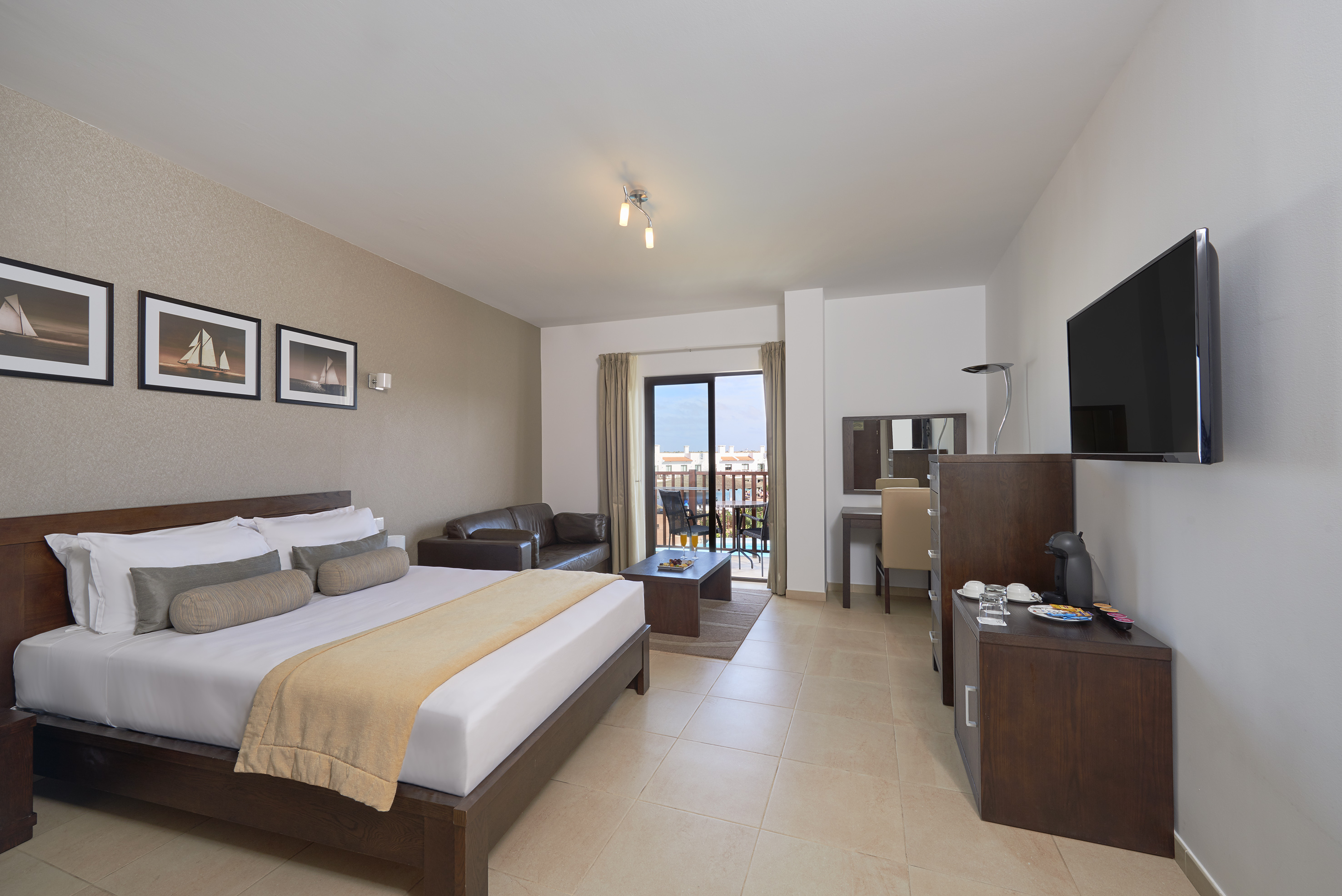 a bedroom with a television and a bed