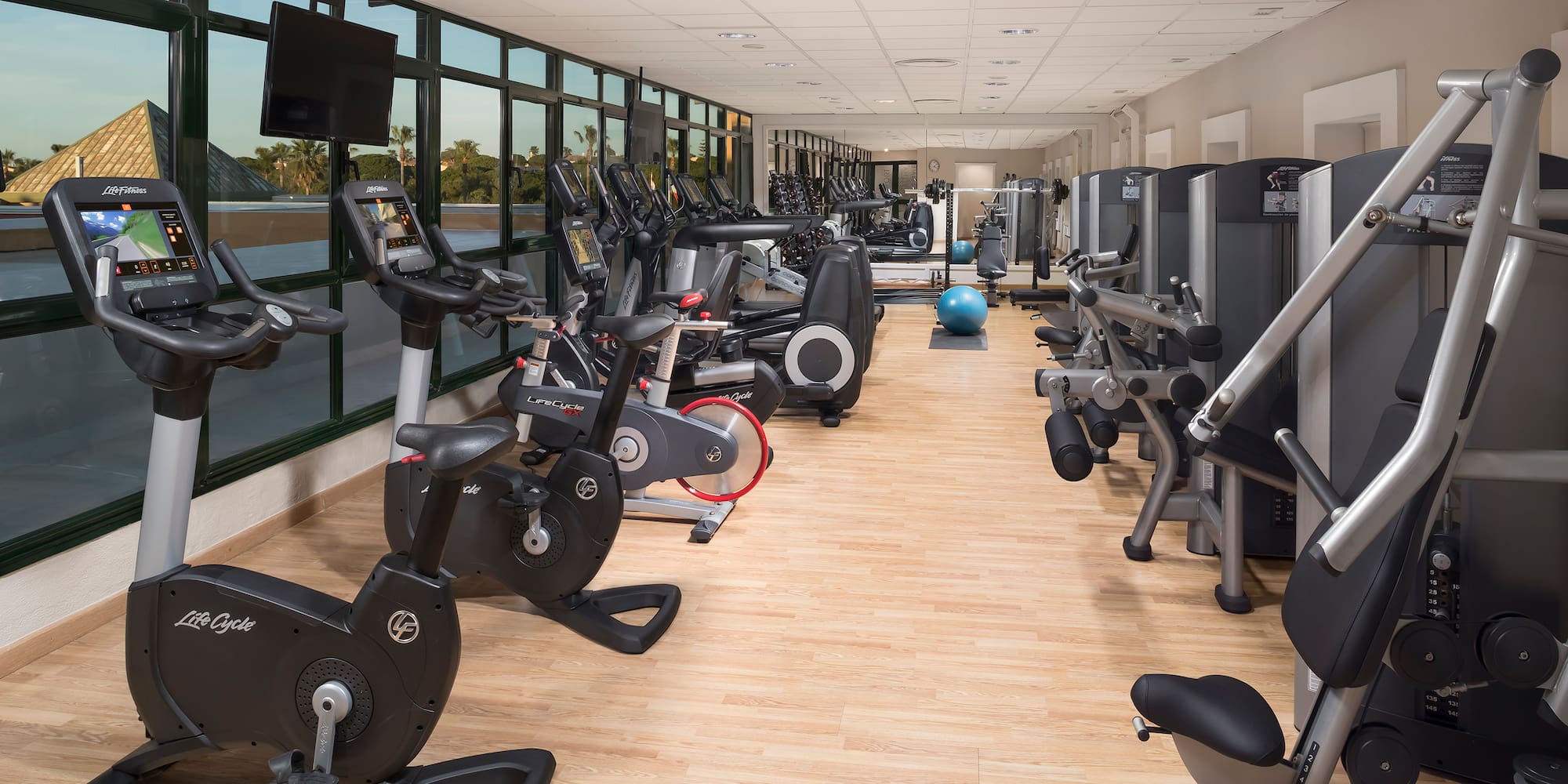 a room with exercise bikes and exercise balls