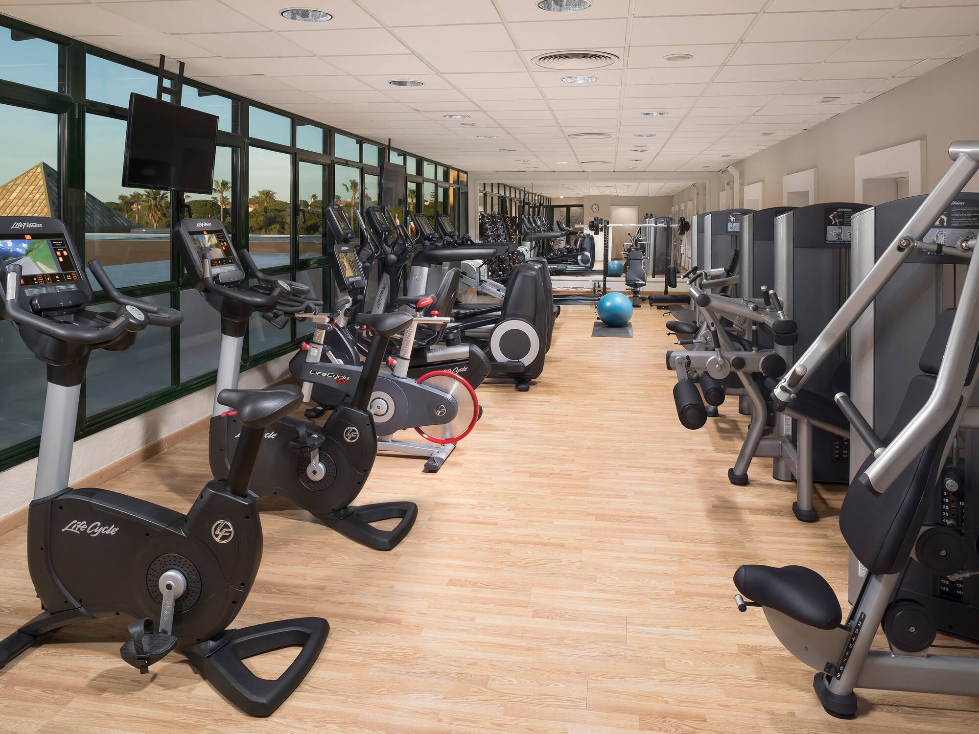 a room with exercise bikes and exercise balls