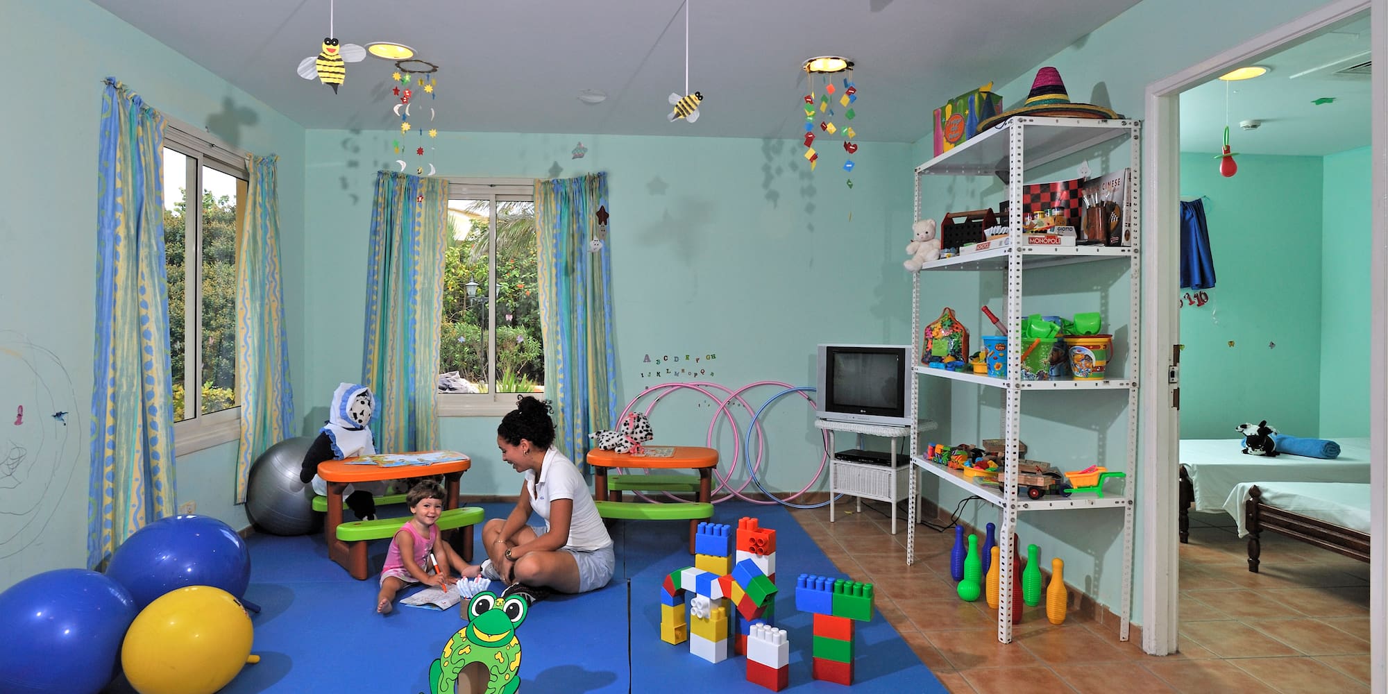 a woman and child in a playroom