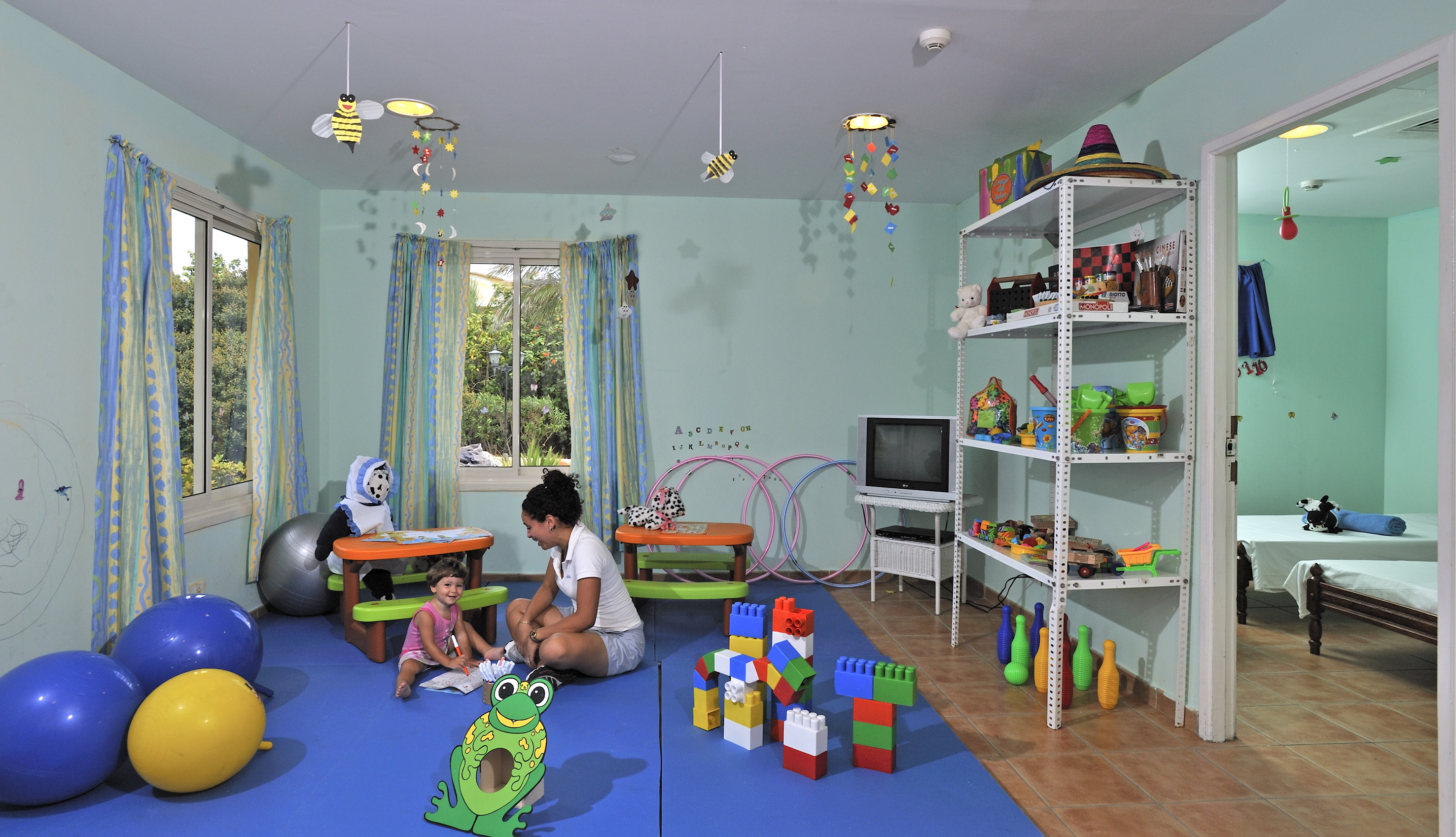 a woman and child in a playroom