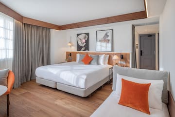 a room with a bed and two beds